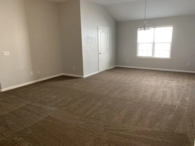 an empty room with windows and entrance