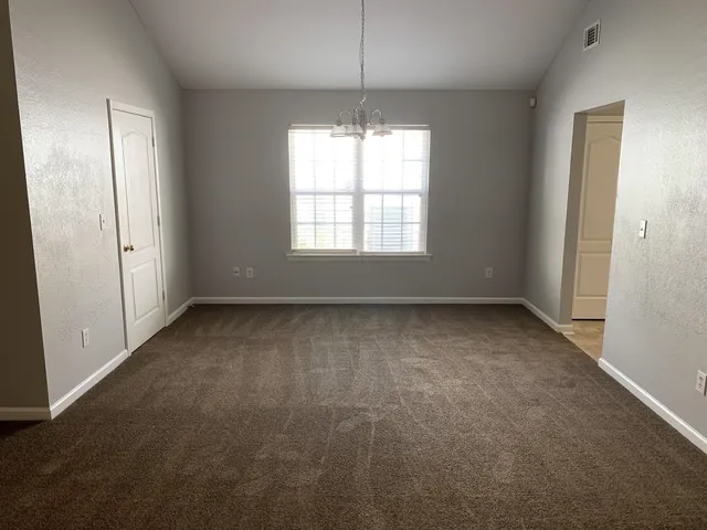 en empty room with windows and entrance