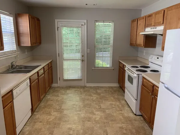 a kitchen with a stove a sink and a microwave