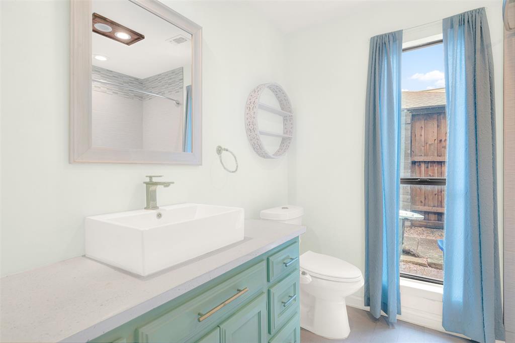 3048 Airhaven Street Dallas, TX 75229 - Photo 11 of 14 a bathroom with a sink a toilet and a mirror