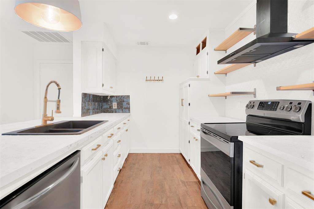 3048 Airhaven Street Dallas, TX 75229 - Photo 2 of 14 a kitchen with stainless steel appliances granite countertop a sink and a stove with white countertops