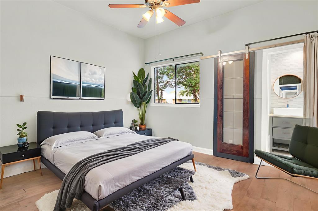 3048 Airhaven Street Dallas, TX 75229 - Photo 7 of 14 a bedroom with a bed and a chandelier