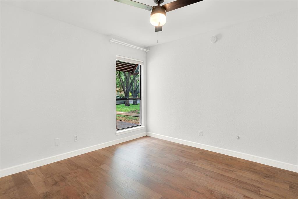 3048 Airhaven Street Dallas, TX 75229 - Photo 10 of 14 an empty room with wooden floor fan and windows