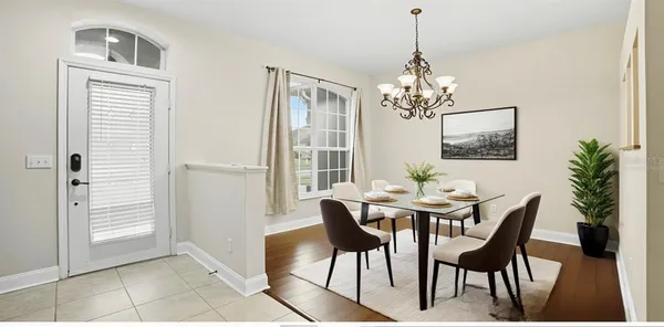 a view of a dining room with furniture and chandelier
