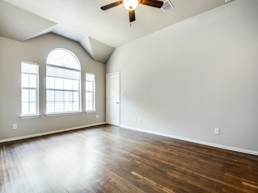 5924 Legend Lane The Colony, TX 75056 - Photo 13 of 27 an empty room with wooden floor chandelier fan and windows