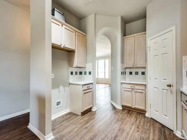 a kitchen with white cabinets and white appliances