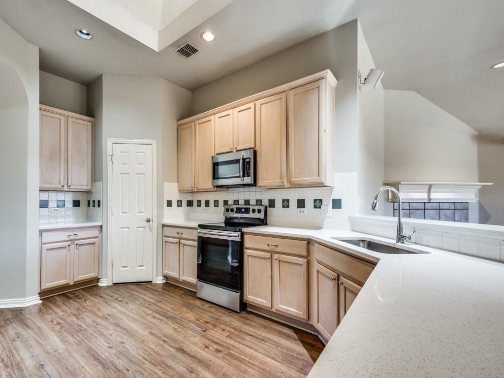 5924 Legend Lane The Colony, TX 75056 - Photo 6 of 27 a kitchen with a sink stove oven and cabinets