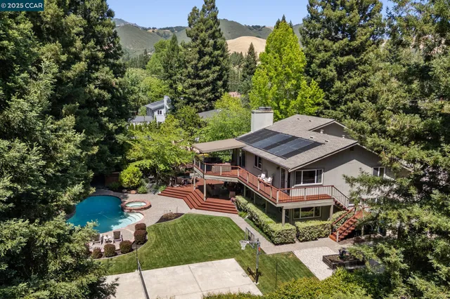an aerial view of a house with a yard