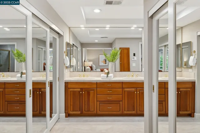 a spacious bathroom with a granite countertop sink mirror and shower