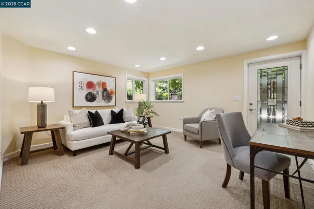 a living room with furniture and a potted plant