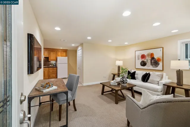 a living room with furniture and kitchen view