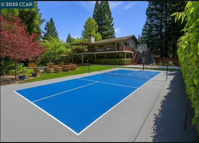 a view of outdoor space with swimming pool and trees in the background