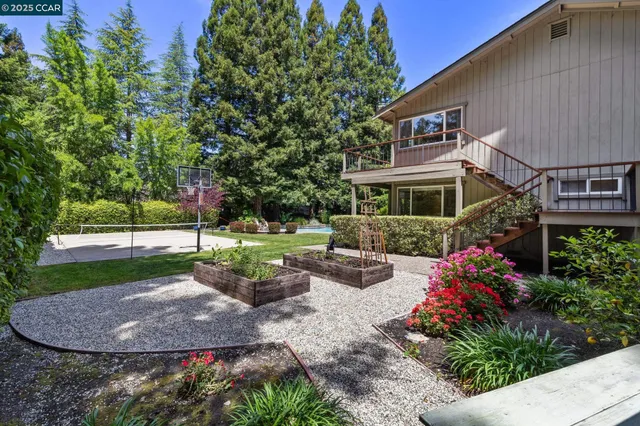a view of a house with backyard and sitting area