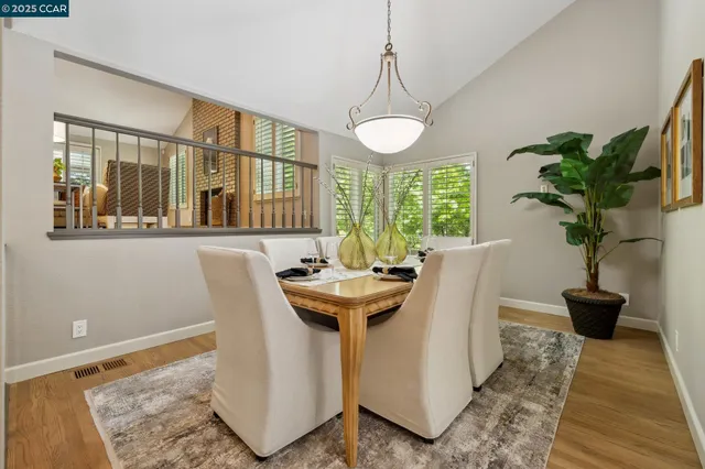 a view of a dining room with furniture window and wooden floor
