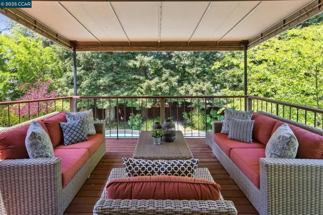 a balcony with furniture and a potted plant