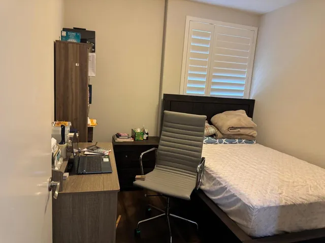 a bedroom with a bed and a table