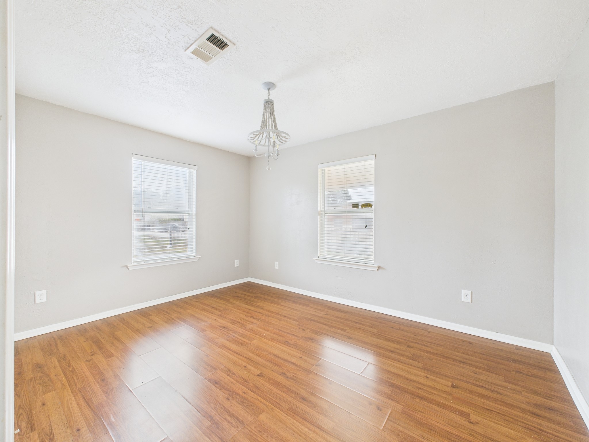 10130 Sussex Lane Houston, TX 77041 - Photo 14 of 20 wooden floor in an empty room with a window