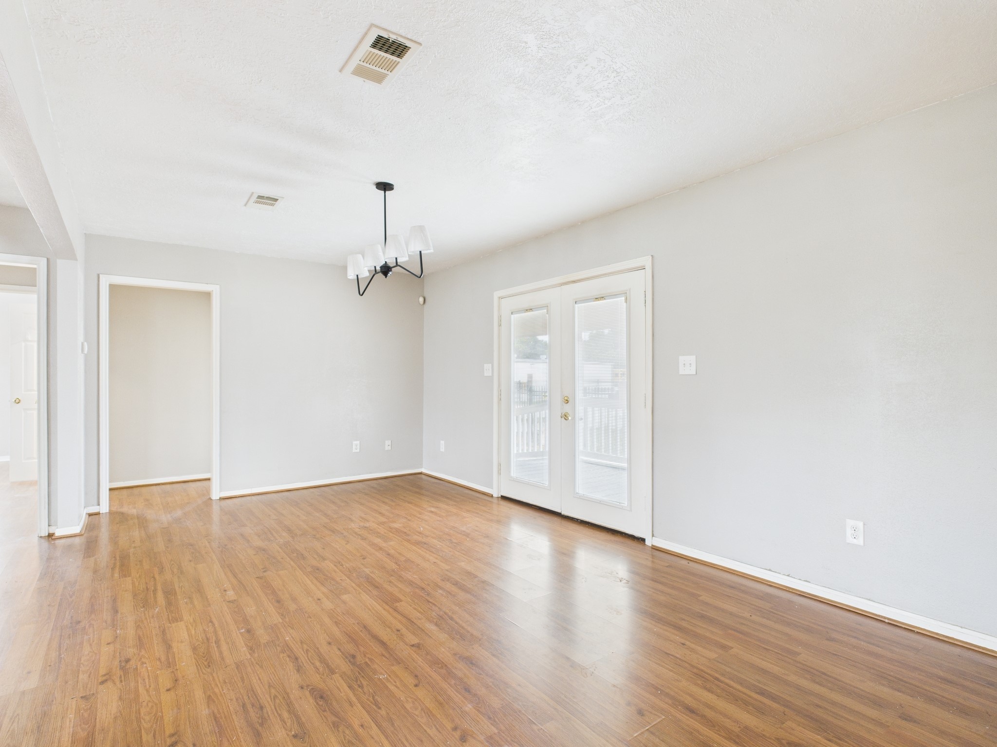 10130 Sussex Lane Houston, TX 77041 - Photo 6 of 20 an empty room with wooden floor ceiling fan and windows
