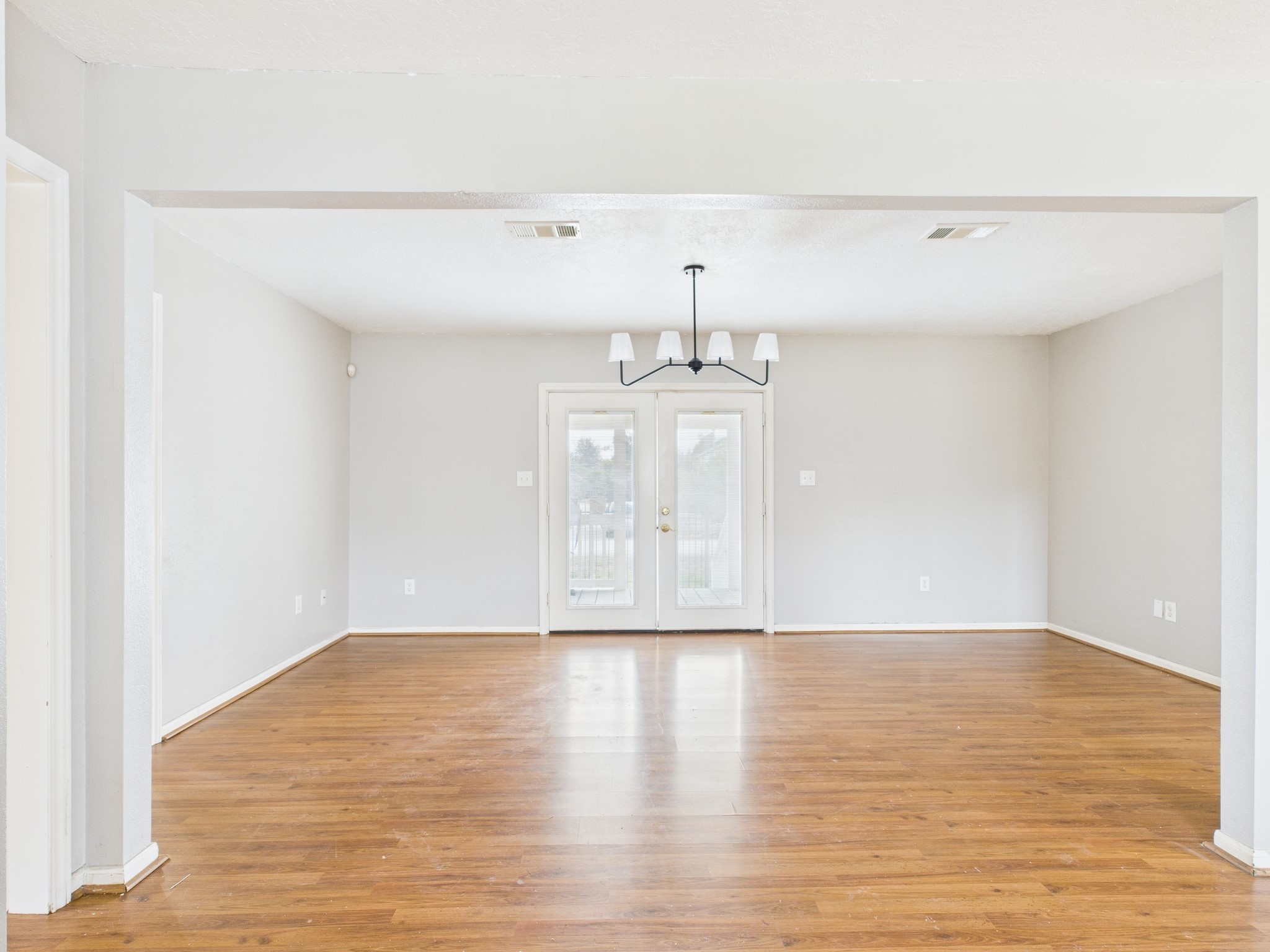10130 Sussex Lane Houston, TX 77041 - Photo 8 of 20 a view of an empty room with wooden floor