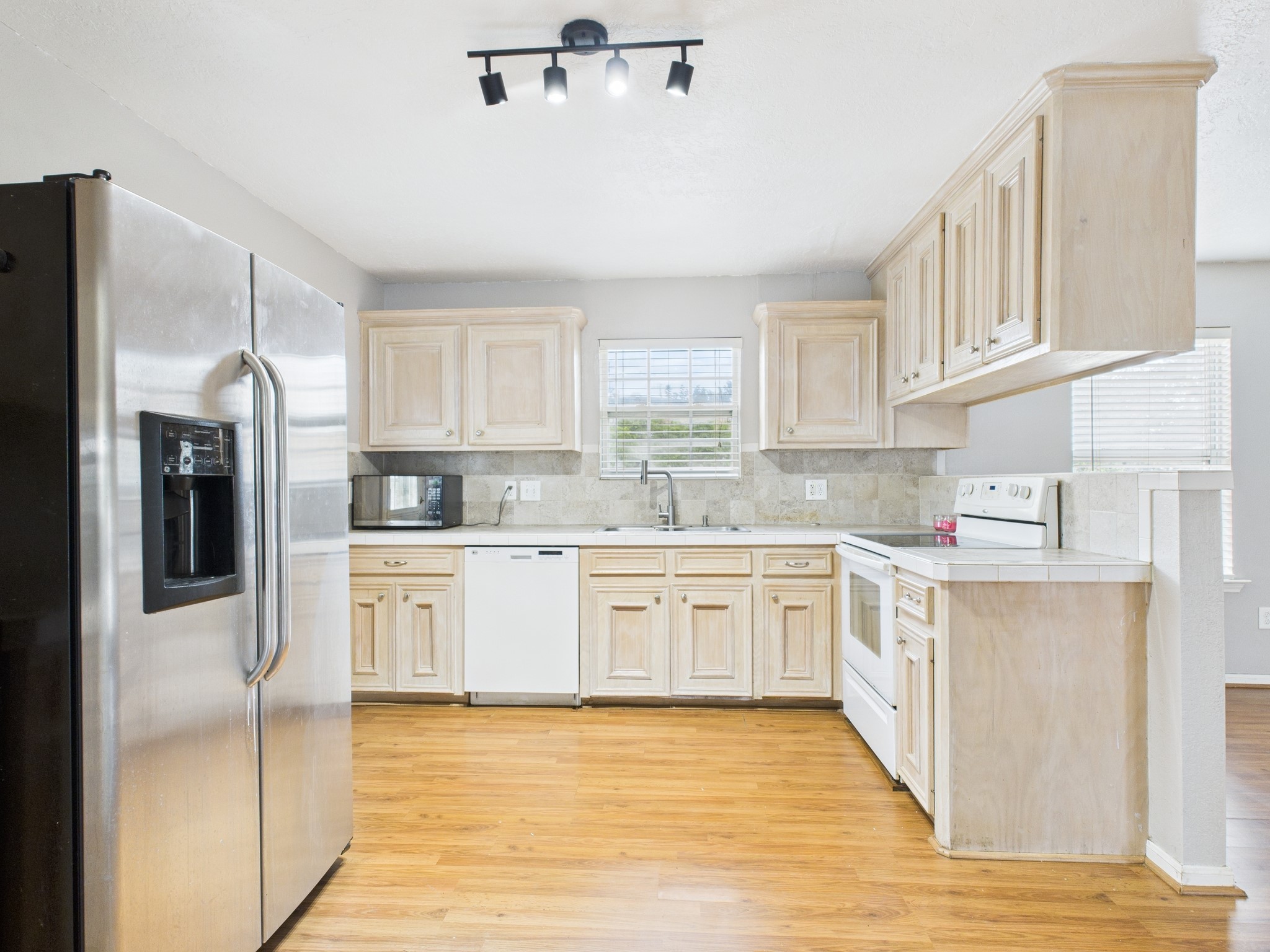 10130 Sussex Lane Houston, TX 77041 - Photo 9 of 20 a kitchen with stainless steel appliances granite countertop a refrigerator sink and cabinets