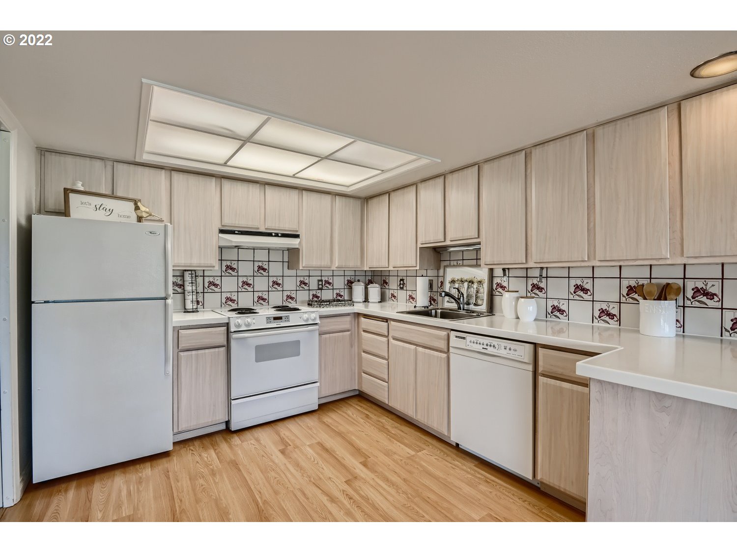 1503 Southwest Hall Street Portland, OR 97201 - Photo 8 of 17 a kitchen with granite countertop white cabinets and white appliances