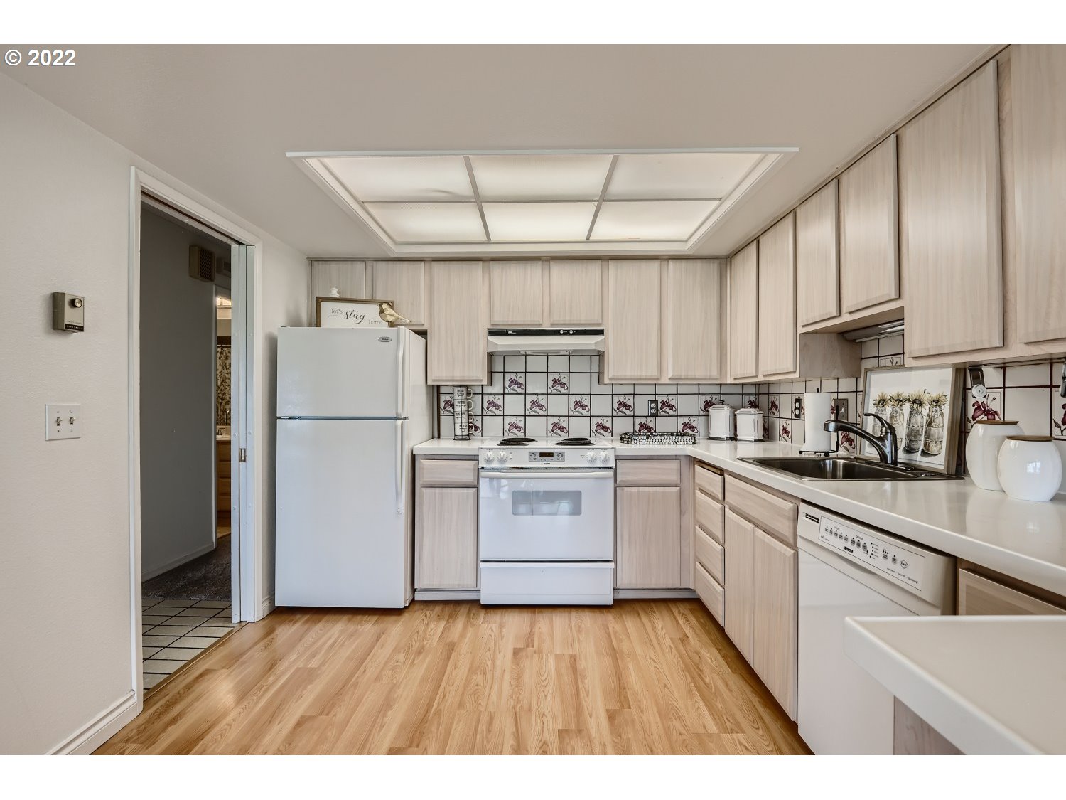 1503 Southwest Hall Street Portland, OR 97201 - Photo 9 of 17 a kitchen with a refrigerator a sink and cabinets