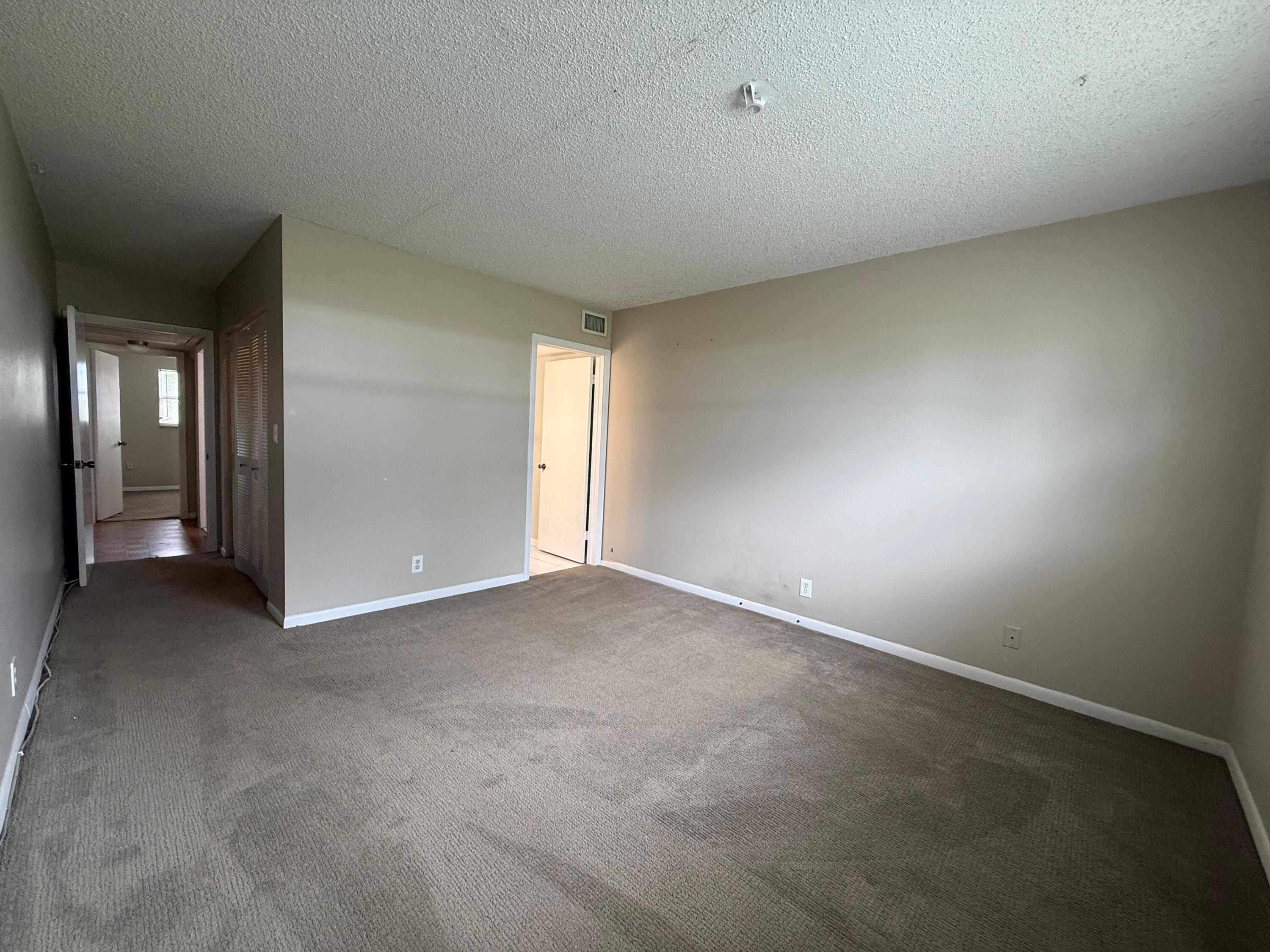 2141 Woolbright Road, Unit L106 Boynton Beach, FL 33426 - Photo 8 of 11 Primary Bedroom with Ensuite