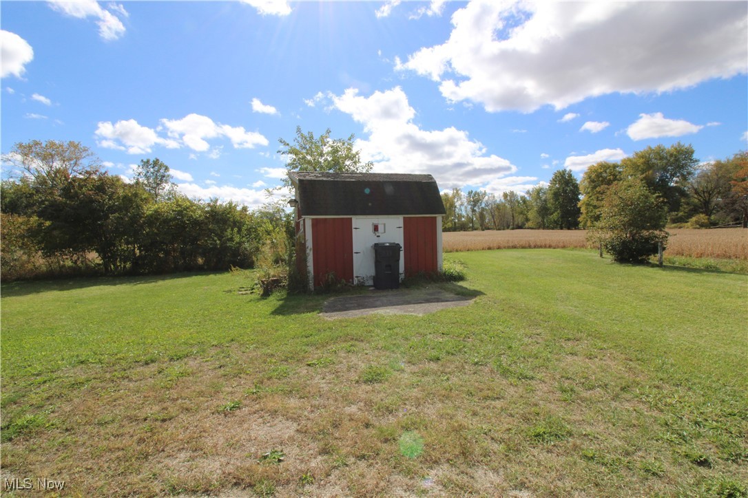 5084 West Fremont Road Port Clinton, OH 43452 - Photo 2 of 19 View of green lawn featuring a shed