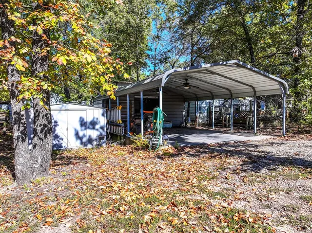 a view of a patio with table and chairs under an umbrella