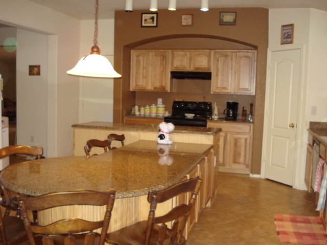 29062 North Mountain View Road San Tan Valley, AZ 85143 - Photo 7 of 15 a kitchen with a table chairs and a refrigerator