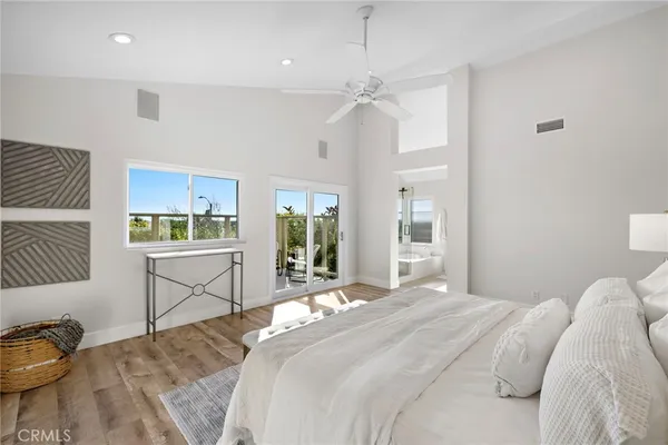 a bathroom with a sink a granite countertop tub mirror and vanity