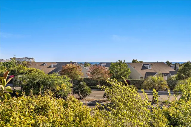 a view of wooden floor in an empty room with a window