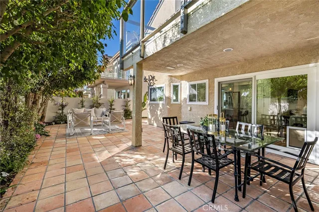 a view of a patio with a table and chairs and potted plants