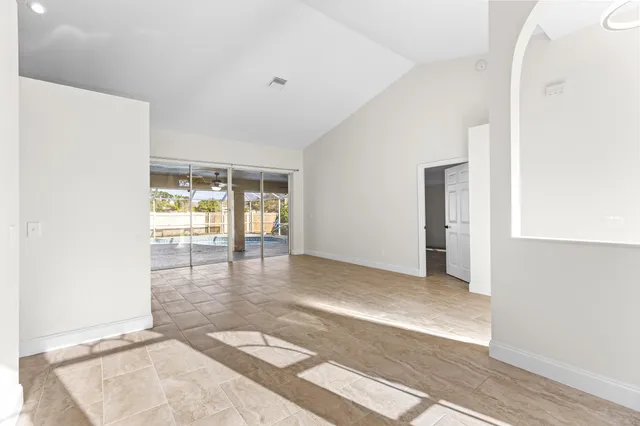 a view of a big room with windows and chandelier