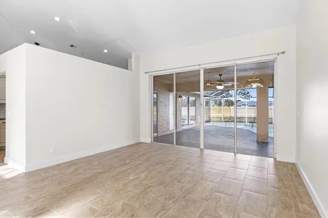 a view of an empty room with glass door