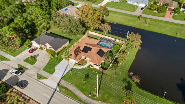 an aerial view of a house with a yard basket ball court