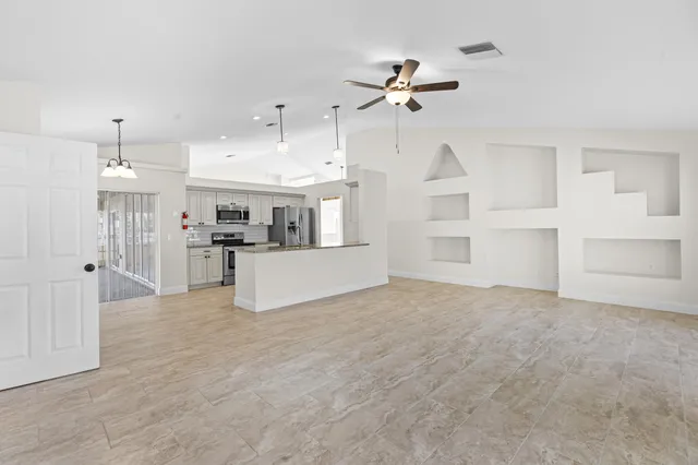 a view of a kitchen with furniture and wooden floor