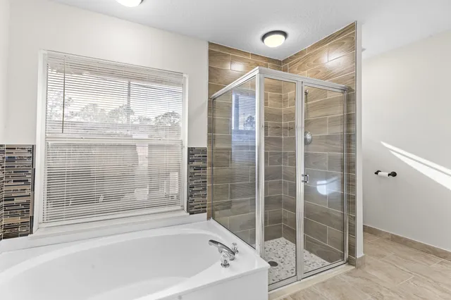 a bathroom with a bathtub and shower