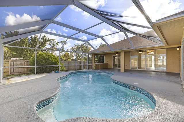 a view of a house with a backyard porch and sitting area