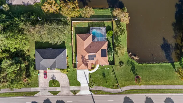an aerial view of a house with a garden and trees