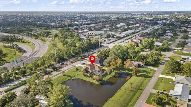 an aerial view of a house with a yard and lake view