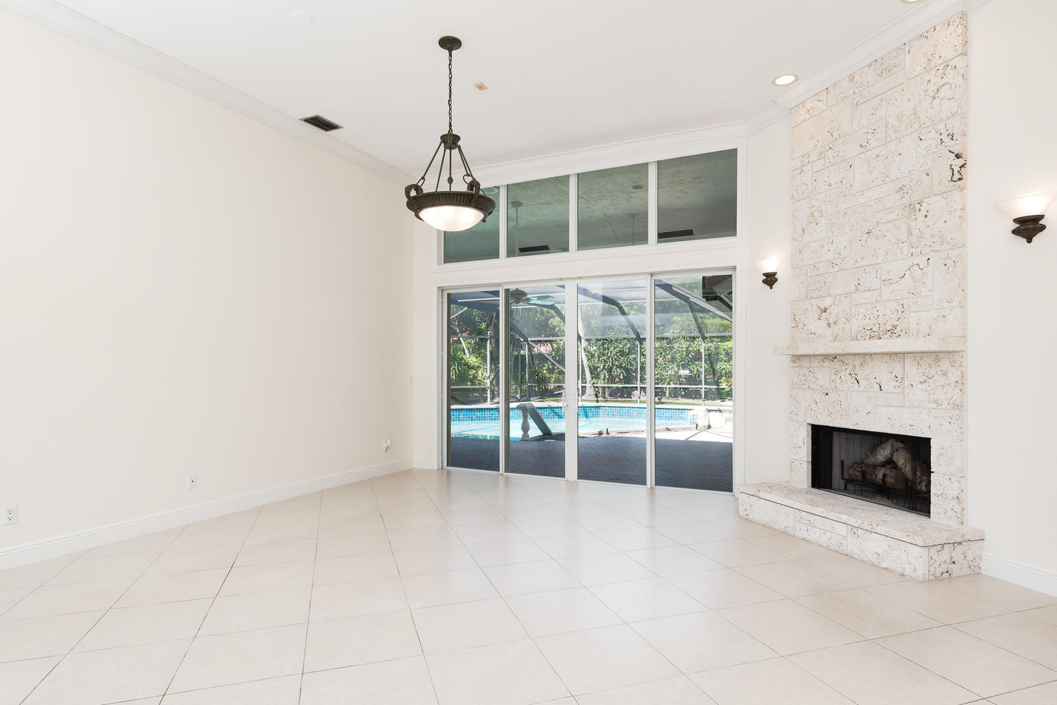 2245 Parkside Street Boca Raton, FL 33486 - Photo 4 of 34 a view of an empty room with a fireplace and a window
