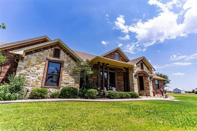 a front view of house with yard and green space