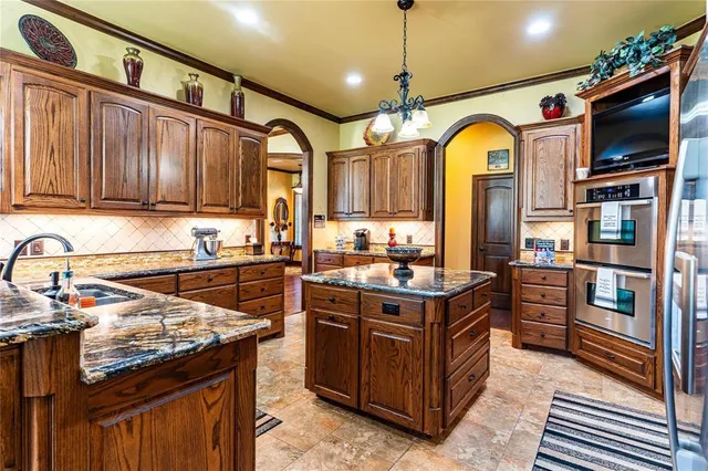 a kitchen with stainless steel appliances granite countertop a stove and a sink