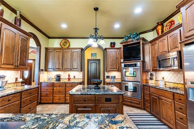 a kitchen with stainless steel appliances granite countertop a stove and a sink