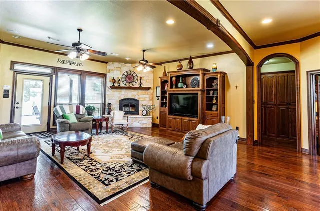 a living room with furniture fireplace and wooden floor