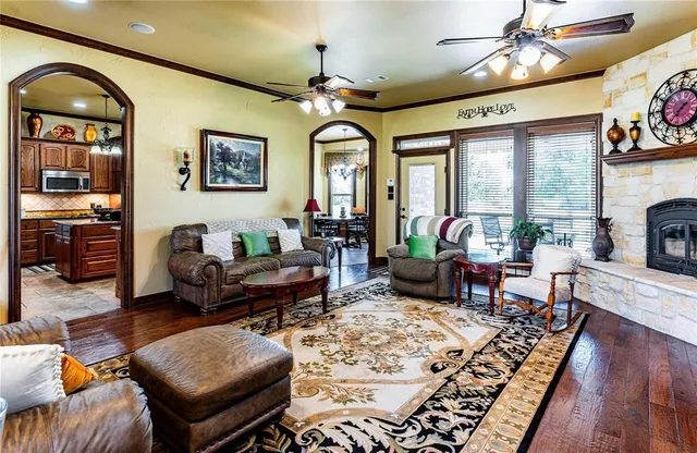 a living room with furniture a chandelier and a large window