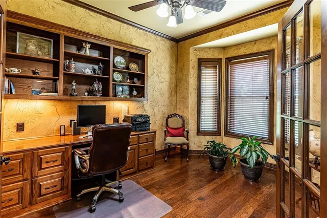 a view of a workspace with furniture and a window