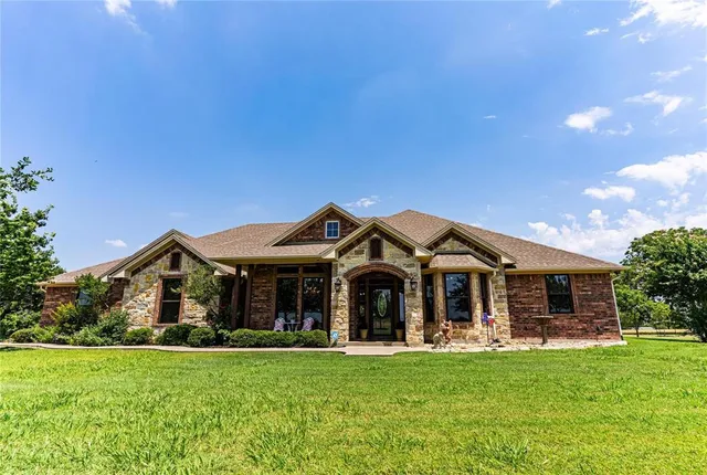 a front view of a house with swimming pool having outdoor seating