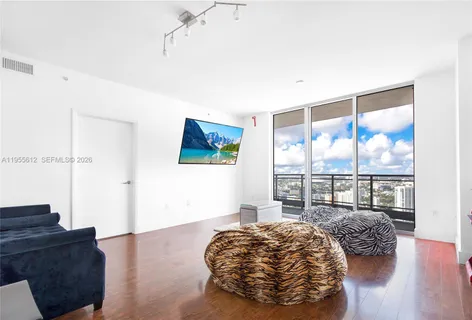 a bedroom with a bed and glass window